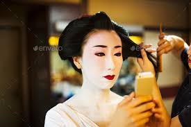 a modern geisha or maiko woman being