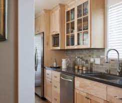 A white subway tile kitchen backsplash can look great with dark brown cabinets like you can see in this kitchen. Maple Cabinets Ideas On Foter Maple Kitchen Cabinets Galley Kitchen Design Kitchen Design
