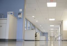 Bright White Ceiling Panels For A Hospital Corridor Helps Provide Good Lighting For Patients And Staff Hospital Interior Cool Lighting White Ceiling