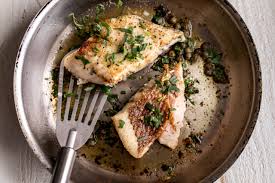 pan seared white fish cooking with