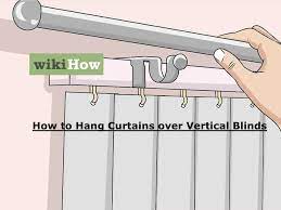 hang curtains over vertical blinds