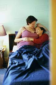 Mother and son talking in bed - Stock Photo - Dissolve