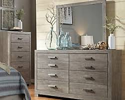 Replicated wood grain lends a warm, country style to this dresser mirror. Black Bedroom Dressers Chests Of Drawers Ashley Furniture Homestore