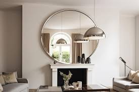 A Large Round Mirror Hangs Above A
