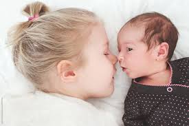 baby sister eskimo kissing