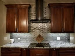 This elegant white and gray kitchen showcases modern design, from the decorative tile backsplash that runs from the marble countertops to the ceiling. Kitchen Tile Backsplash Ideas Ys Way Flooring
