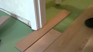 install floating wood floor under door