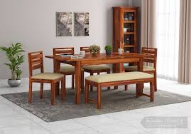 These often very stylish looking pieces of furniture allow you to have a feast for the whole neighbourhood or, when in their smallest state, just have a eye pleasing modest sized table. Buy Advin 6 Seater Extendable With Bench Dining Set Honey Finish Online In India Wooden Street