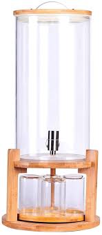 glass drink dispenser on wooden stand