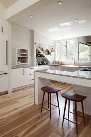 how wood flooring warms up a white kitchen
