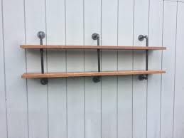 Reclaimed Wood And Pipe Bookshelf Wall