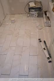 During installation, apply glue or caulk around the edges of the planks. Tiled Bathroom Floor Progress Plus A Few Tiling Tips Addicted 2 Decorating