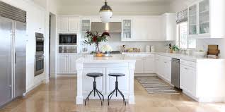 White kitchen cabinets, black countertops and white subway tile with white grout. White Kitchen Cabinets Design Ideas Savillefurniture