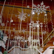 Snowflakes And Twinkling Lights Hang From The Ceiling Above