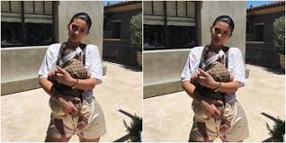 carried stormi in gucci baby carrier