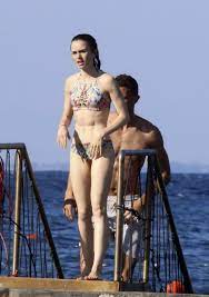 Lily Collins in a Bikini spotted with a Mystery Guy at a Beach in Ischia,  Italy