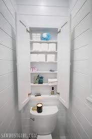 Diy bathroom cabinet supplies 2 unfinished stock wall cabinets size 18 w x 30 h x 12 d *depending on your space, you may need to size down the width to 12 w or even opt for just one cabinet over two stacked 4 feet of crown molding 3 feet of lattice trim Recessed Wall Cabinet For Toilet Paper Storage Sawdust Girl
