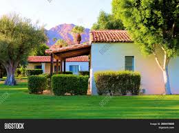 If i could someday build a house from the ground up, i'd love to design something like an hacienda. Spanish Style Hacienda Villas With A Front Porch Surrounded By Lush Manicured Plants And Grass Taken Image Stock Photo 255470503