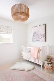 white spindle crib with pale pink