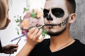 makeup artist makes a demon makeup