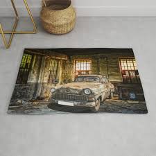 old car in a garage rug by moonfluff