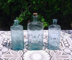 Three Antique Pale Blue Glass Bottles