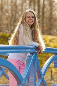 Share the best gifs now >>>. Happy Young Girl With Long Blonde Hair On Bridge In Park Stock Photo Picture And Royalty Free Image Image 20240219