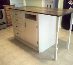 Measure the inside depth of the cabinet bottoms and cut out two pieces of 2x2 wood to match. Old Base Cabinets Repurposed To Kitchen Island Hometalk