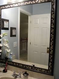 Our bathroom mirror is a huge mirror, 60, and to buy a replacement that size was simply out of our budget. Framing And Tiling A Bathroom Mirror Bathroom Mirrors Diy Mirror Frame Diy Bathroom Mirror Frame