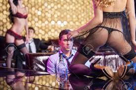 Sexy Strip Tease Dancers Entertain Men In Strip Club. Beautiful Blond Girl  On Foreground In See Through Dress Stock Photo, Picture and Royalty Free  Image. Image 28561276.