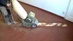 sanding floorboards with red paint
