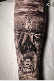 Lion cub reflection tattoo