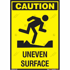caution uneven surface signs