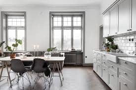 This gorgeous kitchen is fitted with dark gray kitchen cabinets, black hardware and matching black countertops. Grey Kitchen And Dark Herringbone Floors Coco Lapine Designcoco Lapine Design