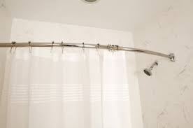 a shower curtain rod up on tile walls