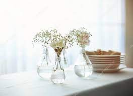 Mini Glass Vases With Flowers On Table