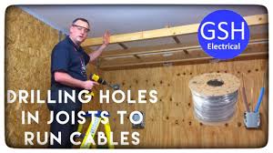 drilling holes in joists to run cables