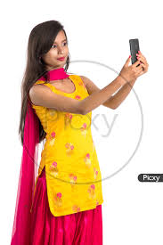 Image of Beautiful Indian Girl Taking Selfie In Smart Phone-UN595284-Picxy