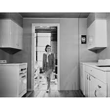 women enters a modern 1940s kitchen