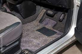 dirty car floor mats of gray carpet