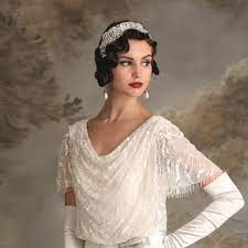 Weave strings of pearls into your curly low bun for a stunning 1920s wedding hairdo. Bridal Styles For Shorter Hair Shorter Bridal Hairstyles Lace Favour