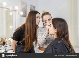 makeup artist in beauty studio stock