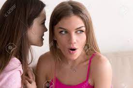 Young Girl Telling Her Best Friend Private Secret. Girlfriend Listening  With Surprised Expression On Face. Best Friends Gossip About People They  Know, Telling Latest Rumors, Sharing Personal News. Stock Photo, Picture and