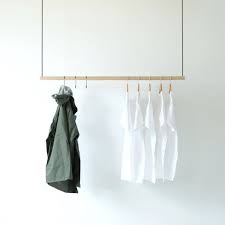 Insert small screws into the holes to prevent the clothes rod from sliding back and forth on the brackets. Hanging Clothes Rack Ceiling Mounted Hanging Clothes Rack Etsy Hanging Clothes Racks Hanging Clothes Retail Clothing Racks
