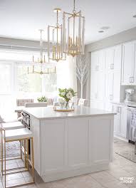 Modern white kitchen cabinets with light wood floor and black pendants. Our Dark To White Kitchen Remodel Before And After Setting For Four