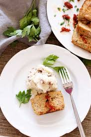 white plate conning turkey meatloaf with sun dried tomato meatloaf with mashed potatoes fork