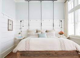 iron rod hanging bed with shiplap walls