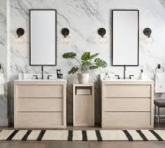 The rough brick wall and unfinished wood table of this space contrast with the smooth, geometrical look of the washbasin and mirror. Bathroom Ideas Inspiration Furniture Decor Pottery Barn
