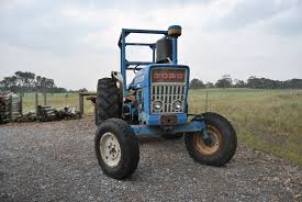 old ford tractor on a agricultural land
