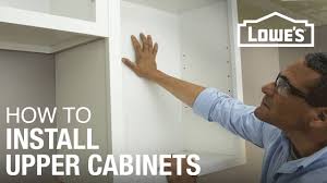 Realistically, you might also want to have a second set of hands for this task. How To Hang Cabinets Youtube